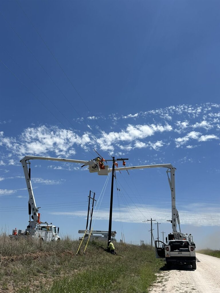 Bucket trucks installing a new distribution pole