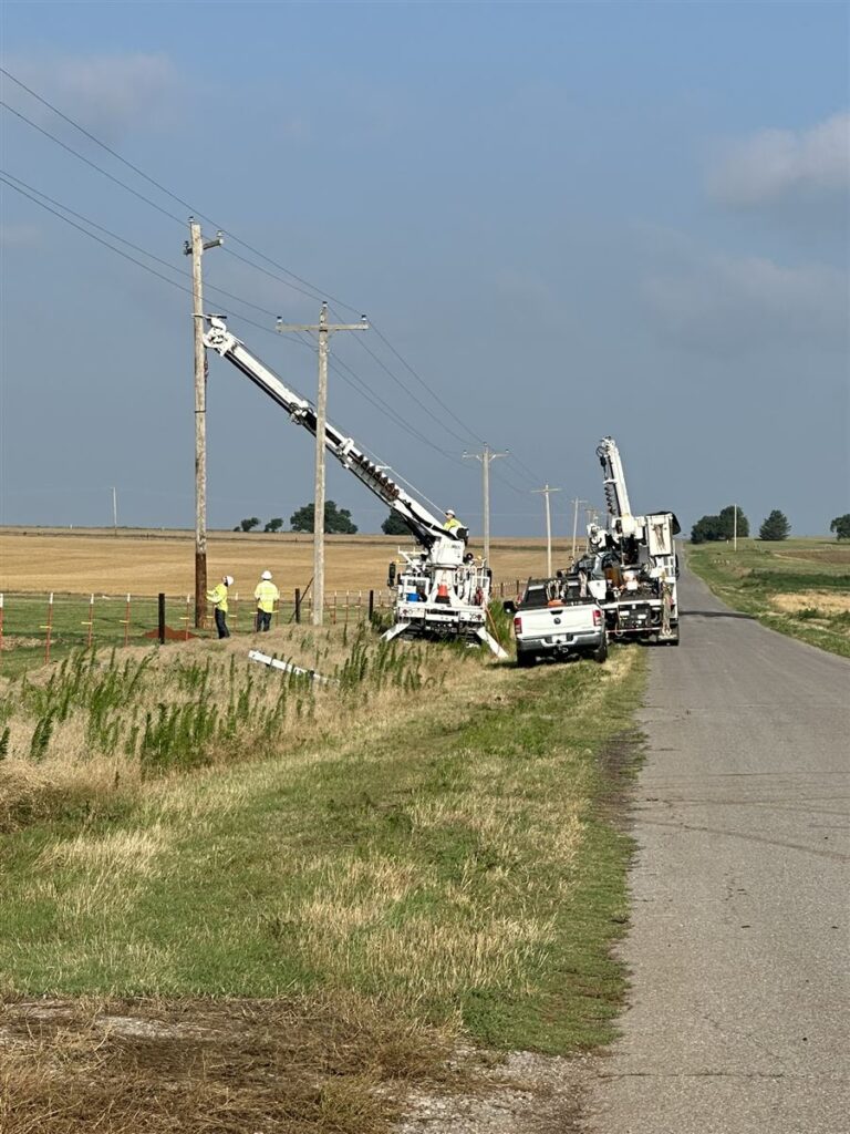 RGC field crew inspecting work on a rural distribution pole line